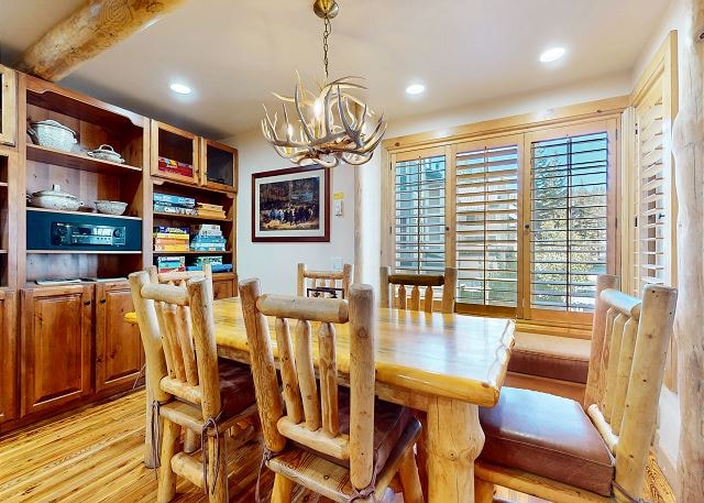 Kitchen with log beam island and knotty pine cabinets